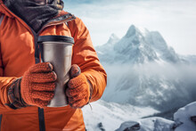 Winter Mountains: Hiker Holding A Cup With A Warm Drink Against A Snowy Background.