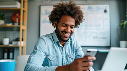 Wall Mural - Happy man using a smartphone during his work in the office