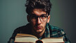 Portrait of a serious student with glasses and open books, ready to study