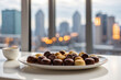 photo of a plate of chocolate in front of a window with a view of the city 8