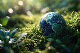 Fototapeta Las - Globe in the grass with bokeh background. Earth Day concept.