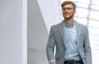© ASDF - confident business man walks through a bright office