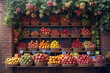 A mix of various fruits, like apples, oranges, and berries,  background of a market stal