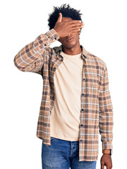 Sticker - Handsome african american man with afro hair wearing casual clothes and glasses covering eyes with hand, looking serious and sad. sightless, hiding and rejection concept