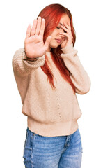 Sticker - Young redhead woman wearing casual winter sweater covering eyes with hands and doing stop gesture with sad and fear expression. embarrassed and negative concept.