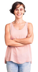 Canvas Print - Beautiful young woman with short hair wearing casual style with sleeveless shirt happy face smiling with crossed arms looking at the camera. positive person.