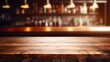  a wooden table top in front of a bar with bottles of liquor on the wall and a blurry background.