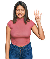 Poster - Young hispanic girl wearing casual t shirt showing and pointing up with fingers number four while smiling confident and happy.