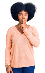 Sticker - Young african american girl wearing casual clothes asking to be quiet with finger on lips. silence and secret concept.