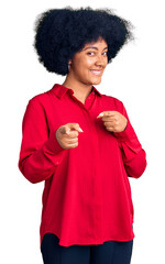 Poster - Young african american girl wearing casual clothes pointing fingers to camera with happy and funny face. good energy and vibes.