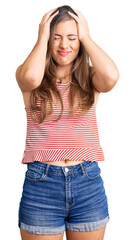 Wall Mural - Beautiful caucasian young woman wearing casual clothes suffering from headache desperate and stressed because pain and migraine. hands on head.