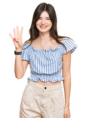 Wall Mural - Young beautiful caucasian girl wearing casual clothes showing and pointing up with fingers number four while smiling confident and happy.