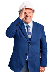 Canvas Print - Senior handsome grey-haired man wearing suit and architect hardhat doing ok gesture with hand smiling, eye looking through fingers with happy face.