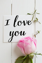 Wall Mural - I love you card with pink peony on white wooden background.