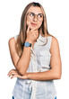 © Krakenimages.com - Hispanic young woman wearing casual white shirt with hand on chin thinking about question, pensive expression. smiling with thoughtful face. doubt concept.