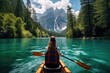 A woman effortlessly glides through the river in her canoe, experiencing the joys of outdoor recreation, Beautiful woman kayaking on a stunning mountain lake surrounded by green trees, AI Generated