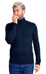 Sticker - Young handsome blond man wearing casual turtleneck sweater looking stressed and nervous with hands on mouth biting nails. anxiety problem.