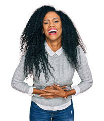 Sticker - Middle age african american woman wearing casual clothes smiling and laughing hard out loud because funny crazy joke with hands on body.