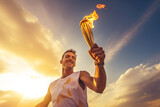 Fototapeta  - A happy smiling male athlete solemnly carries the Olympic flame against the sky
