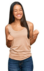 Sticker - Beautiful hispanic woman wearing casual clothes excited for success with arms raised and eyes closed celebrating victory smiling. winner concept.