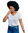 Young african american woman wearing casual white t shirt feeling unwell and coughing as symptom for cold or bronchitis. health care concept.