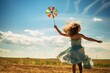 A girl in a dress runs through a field with a children's toy windmill, a weather vane rotates in the wind