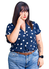 Poster - Young plus size woman wearing casual clothes pointing to the eye watching you gesture, suspicious expression