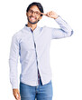 © Krakenimages.com - Handsome hispanic man wearing business shirt and glasses smiling pointing to head with one finger, great idea or thought, good memory