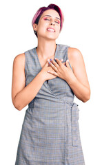 Poster - Young beautiful woman with pink hair wearing casual clothes smiling with hands on chest with closed eyes and grateful gesture on face. health concept.