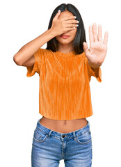 Sticker - Young brunette arab woman wearing casual clothes covering eyes with hands and doing stop gesture with sad and fear expression. embarrassed and negative concept.