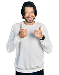 Poster - Middle age caucasian man wearing casual clothes success sign doing positive gesture with hand, thumbs up smiling and happy. cheerful expression and winner gesture.