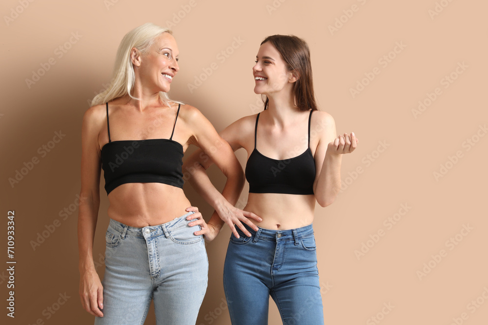 Body positive women on beige background