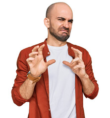 Poster - Young hispanic man wearing casual clothes disgusted expression, displeased and fearful doing disgust face because aversion reaction. with hands raised