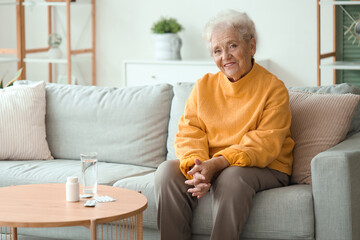 Wall Mural - Senior woman with pills at home