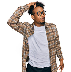Wall Mural - Young african american man with beard wearing casual clothes and glasses smiling confident touching hair with hand up gesture, posing attractive and fashionable