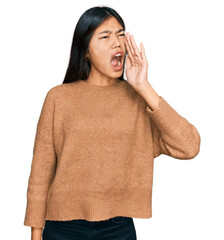 Sticker - Beautiful young asian woman wearing casual winter sweater shouting and screaming loud to side with hand on mouth. communication concept.