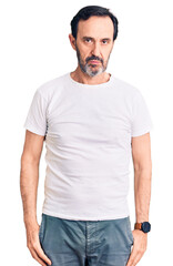 Sticker - Middle age handsome man wearing casual t-shirt relaxed with serious expression on face. simple and natural looking at the camera.