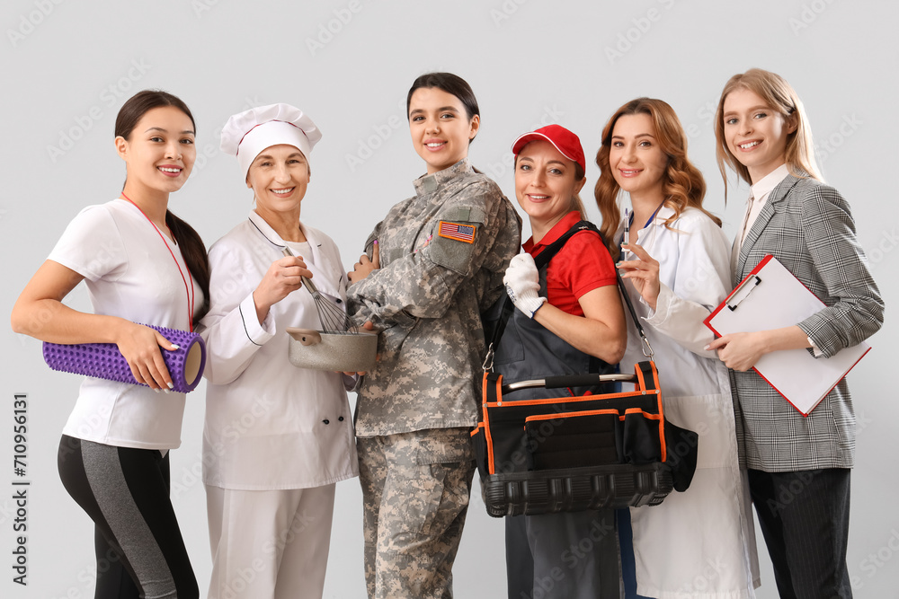 Women of different professions on grey background