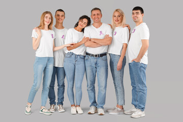 Wall Mural - People with lavender awareness ribbons on light background. World Cancer Day