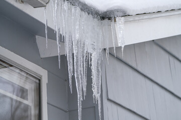 Wall Mural - winter house with icicle and snow on the roof