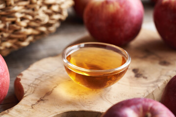 Wall Mural - Apple cider vinegar in a small glass bowl