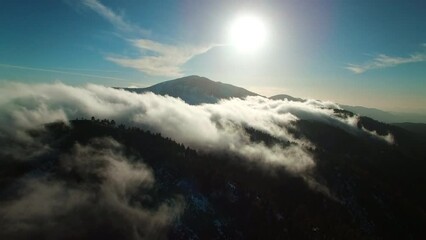 Wall Mural - Aerial Panning Shot Of Clouds Over Snow Covered Jungle On Mountains During Tranquil Weather - Lake Arrowhead, California