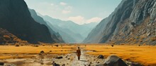 Man Walking Alone Through A Vast Desert Canyon