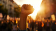 The energy of dissent is encapsulated in a raised fist at a political demonstration, symbolizing t