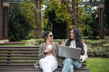 couple latin and caucasian girls with computer