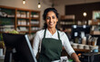 © Malchevska Studio - Indian smiling woman working as a cashier in the store