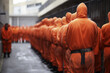 Inmates in a penitentiary center. Group of unrecognizable prisoners in orange uniform in jail. Lineup of anonymous people with prison outfit.