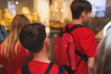 group of students and school pupils in a science museum exhibition, excursion tour with guide, a doc