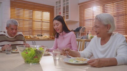 Wall Mural - Asian lovely family having lunch, enjoy eating party in house together. 