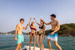 © Kawee - Group of diverse friends drink champagne while having a party in yacht.